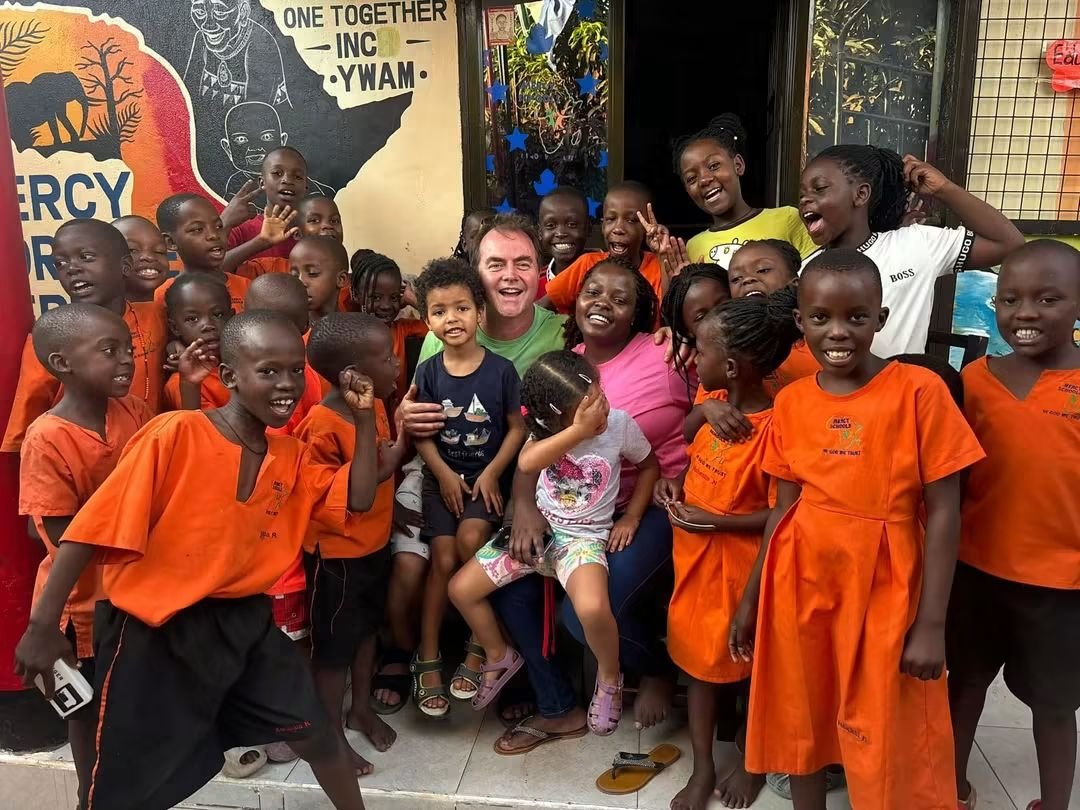 Anthony and Rose with Mercy School children gathered around them at the school